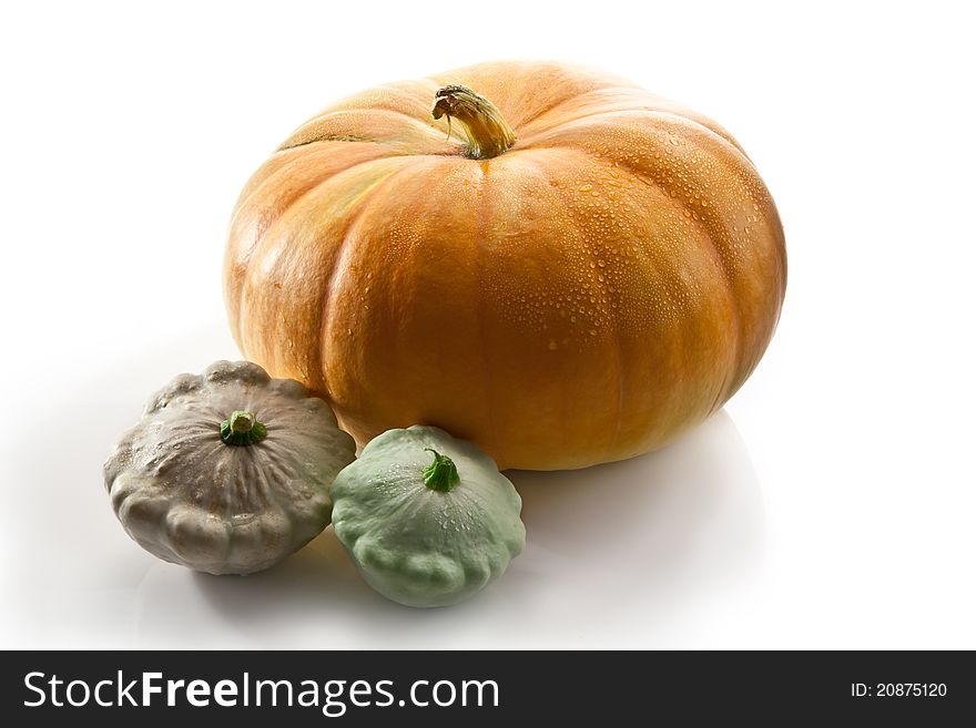 Beautiful pumpkin with water drops and two patissons. Beautiful pumpkin with water drops and two patissons