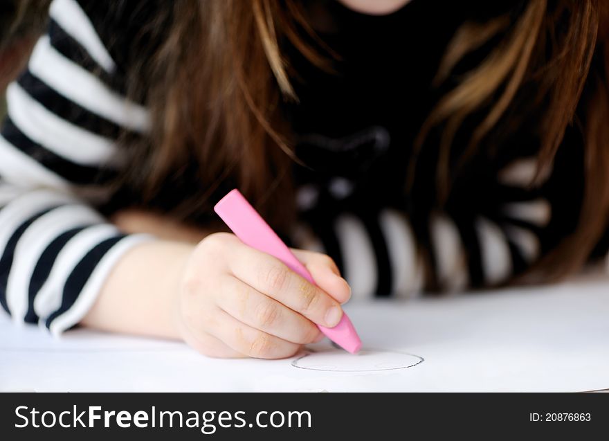 Young girl draws a picture for Halloween party