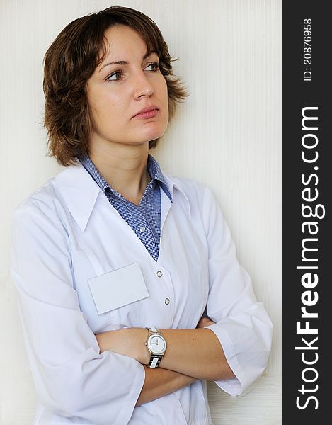 Portrait of a female doctor against a white wall