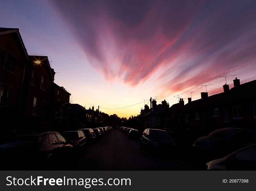 A fantastic sunset lights up the clouds above an urban street in Surrey, UK. A fantastic sunset lights up the clouds above an urban street in Surrey, UK.