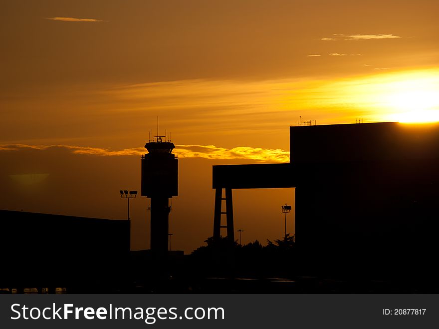 Airport tower framed at dusk.