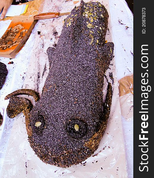 Hungarian confectionery shaping a deep see fish covered with poppy seeds and almond