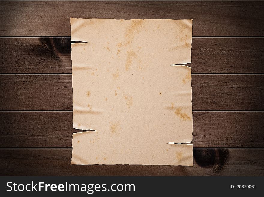 Old yellow paper on wooden wall, clipping path. Old yellow paper on wooden wall, clipping path.