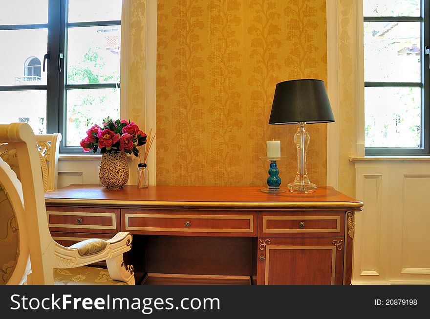 Secretaire and chair in schoolroom, under bright windows in home, shown as bright and quiet environment at home for study and reding. Secretaire and chair in schoolroom, under bright windows in home, shown as bright and quiet environment at home for study and reding.