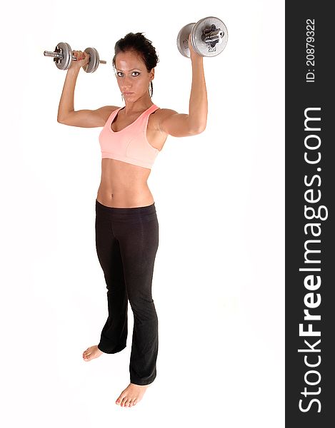 A pretty woman with dumbbells lifting, standing in the studio with bare feet, for white background. A pretty woman with dumbbells lifting, standing in the studio with bare feet, for white background.