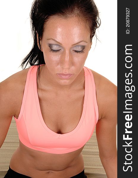 Woman sitting on the floor of a mat, relaxing with yoga with her eyes closed, in close-up, for white background. Woman sitting on the floor of a mat, relaxing with yoga with her eyes closed, in close-up, for white background.