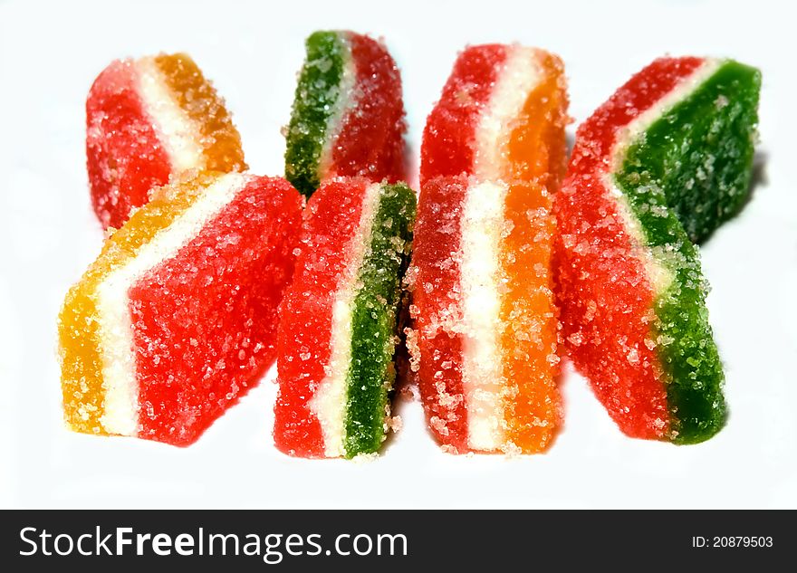 Three-layered multi-colored pieces of jelly isolated. Three-layered multi-colored pieces of jelly isolated