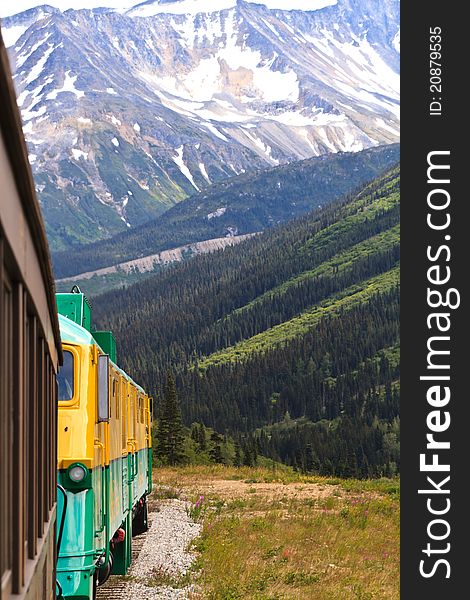 Railroad leading off into the distance in a scenic mountain pass. Railroad leading off into the distance in a scenic mountain pass.