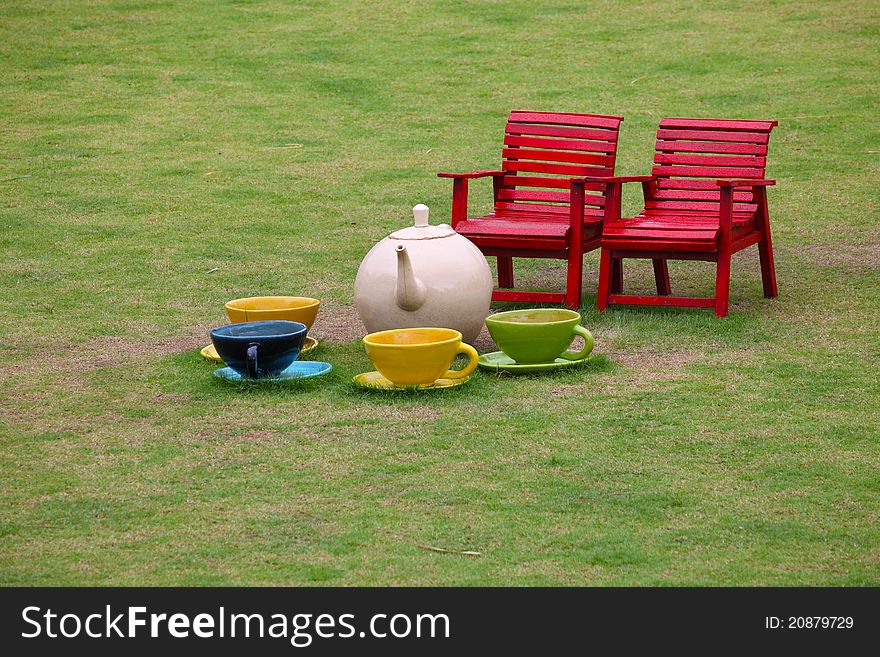 Chairs and ceramic tea set in garden