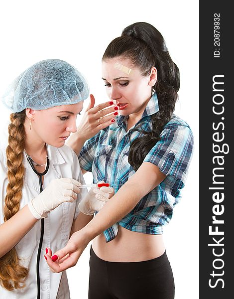 doctor in a white medical coat with a stethoscope takes blood from the vein in patient on white background. doctor in a white medical coat with a stethoscope takes blood from the vein in patient on white background