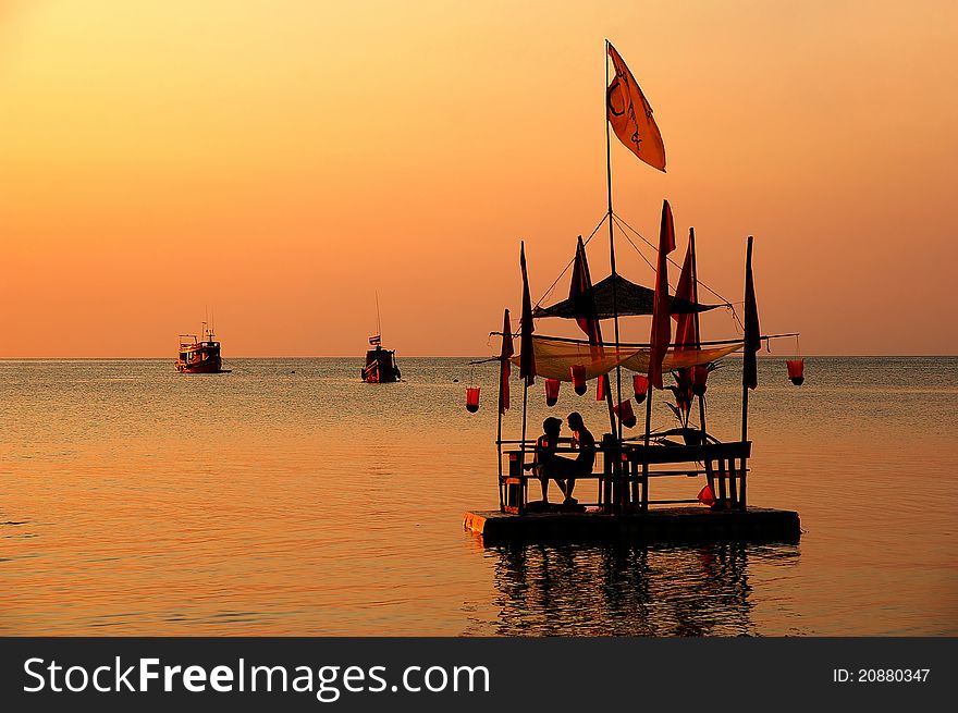 Dark bamboo raft with the table at the sunset. Dark bamboo raft with the table at the sunset