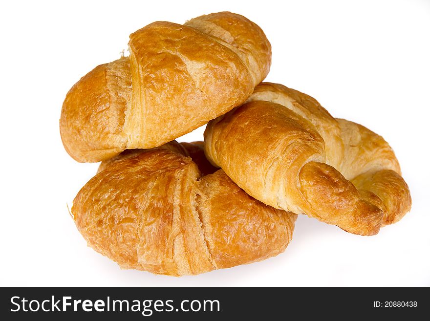 Three croissaints isolated over white background