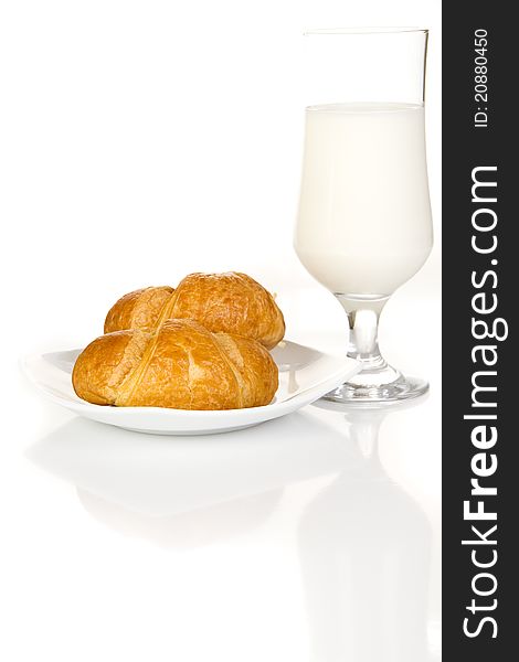 French croissants and milk over white background. French croissants and milk over white background