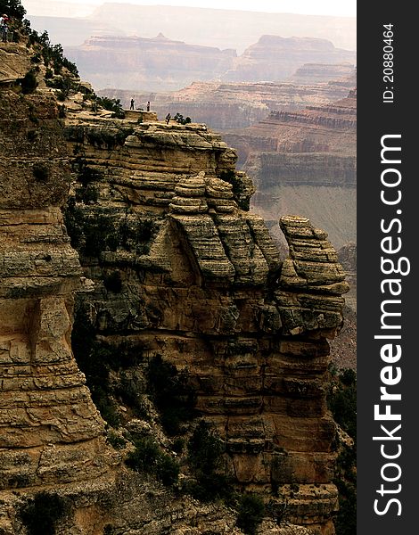 A picture of the Grand Canyon. People standing at an overlook.