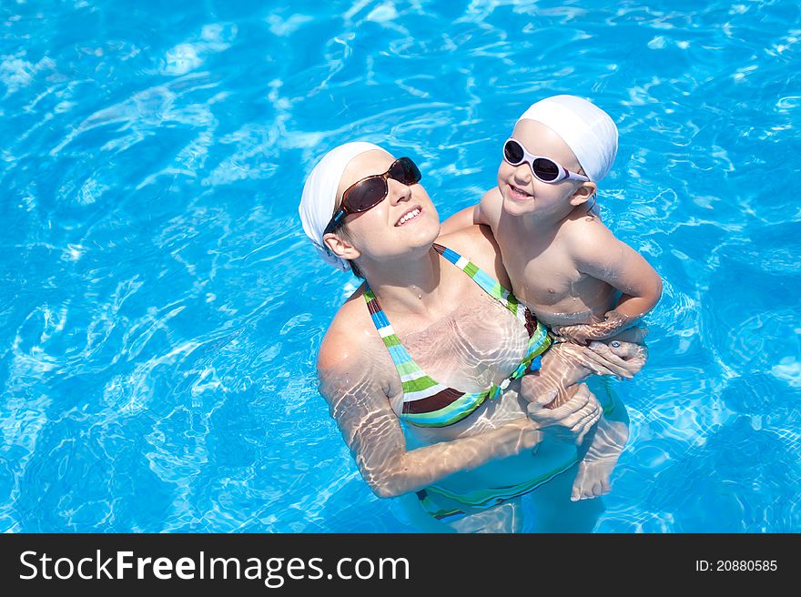 Baby with mother is swimming in pool. Baby with mother is swimming in pool