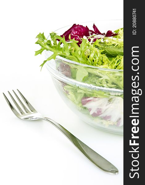 Bowl of fresh salad and fork - isolated