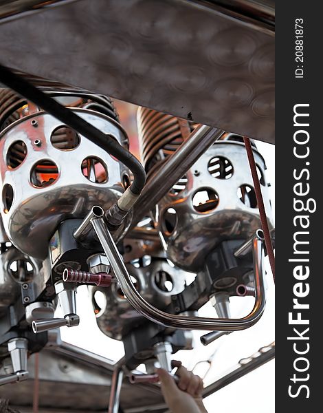 Pilot manning the controls of a hot air balloon engine and jets during flight, portrait, tight crop and headline space