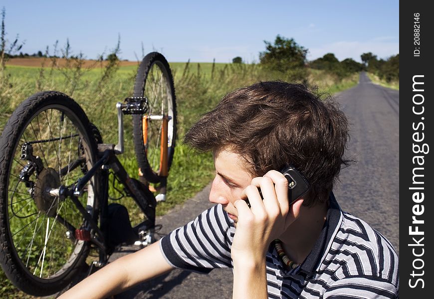 Young cyclist calling for help on the road