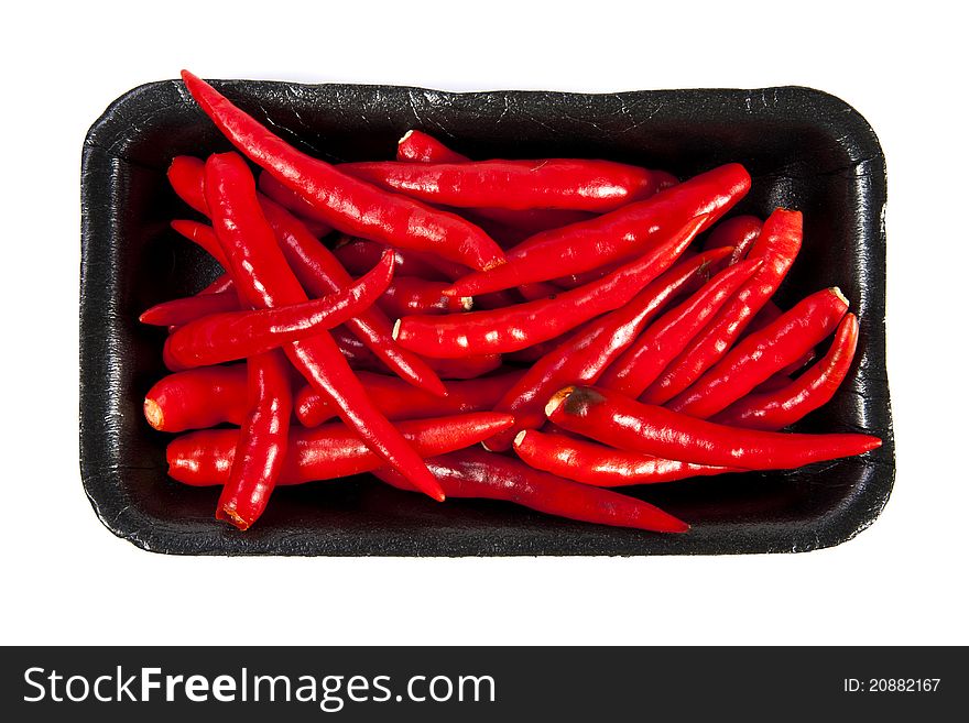 Group of red hot chili pepper with black plate on white background