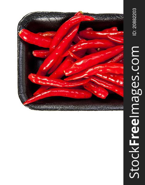 Group of red hot chili pepper with black plate on white background and blank text copy space