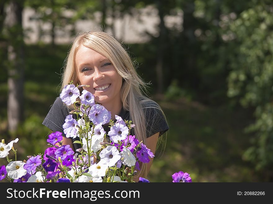 Girl with flowers on a natural green background. Girl with flowers on a natural green background