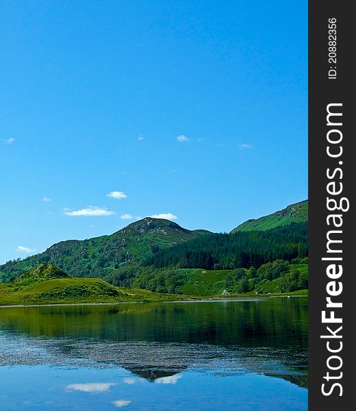 Mountains reflecting on a Scottish Loch on a calm summers day. Mountains reflecting on a Scottish Loch on a calm summers day