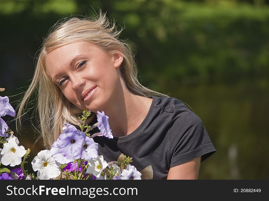 Girl with flowers on a natural green background. Girl with flowers on a natural green background