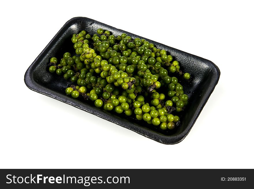 Green pepper cone with black plate on the white background