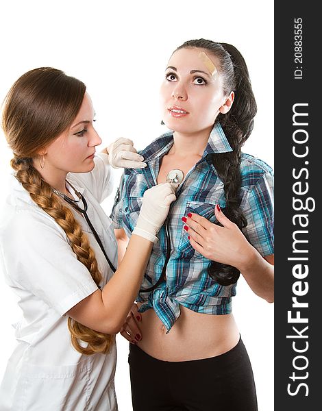 Nurse with long hair listening to breath on his chest phonendoscope a beautiful girl isolated on white background. Nurse with long hair listening to breath on his chest phonendoscope a beautiful girl isolated on white background