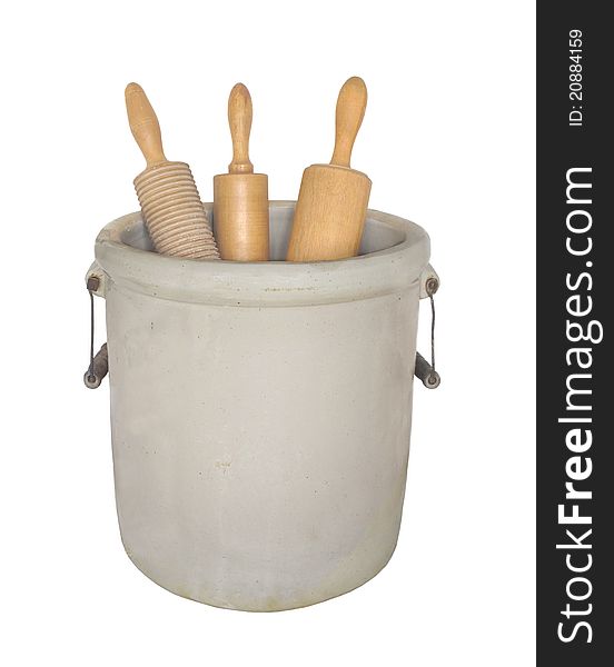 Earthenware crock with handles holding three wooden rolling pins. Isolated on white. Earthenware crock with handles holding three wooden rolling pins. Isolated on white.