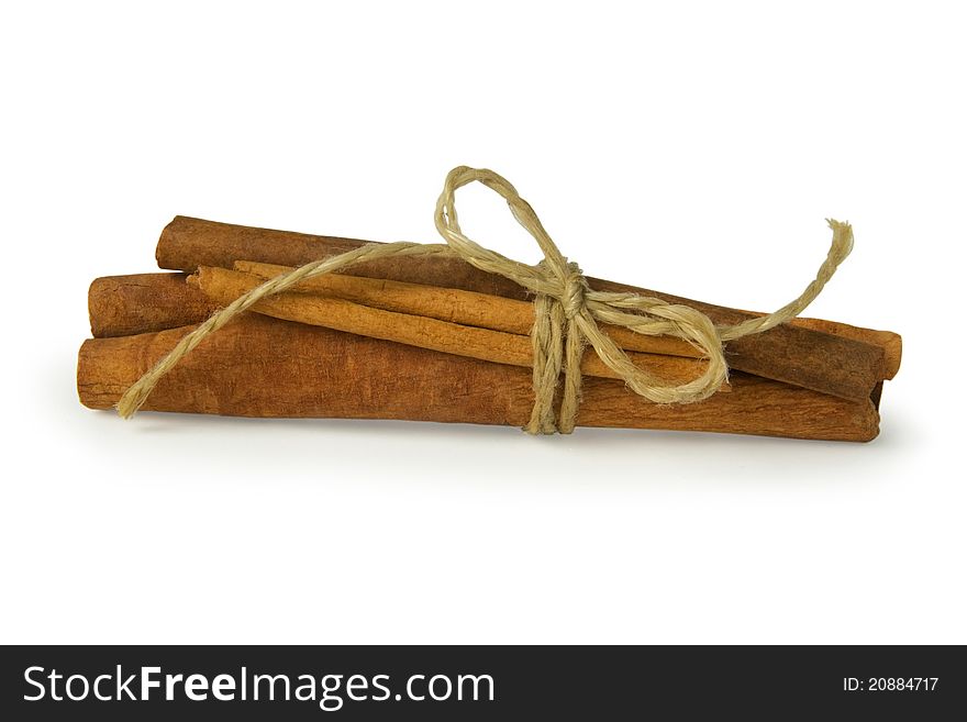 Cinnamon sticks twisted by the string isolated on the white background