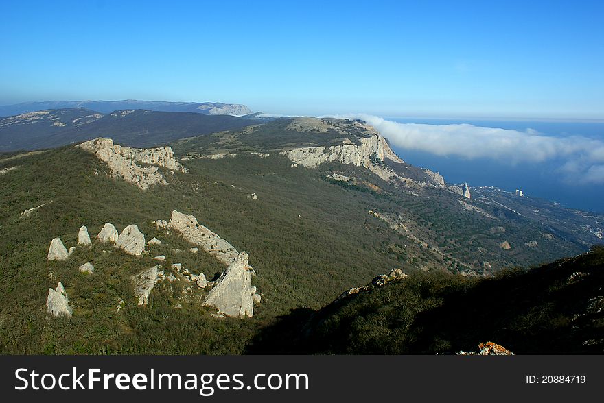 Mountain landscape with clouds and sea