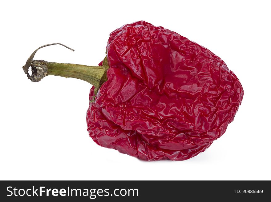 Fading red bell pepper isolated on white background