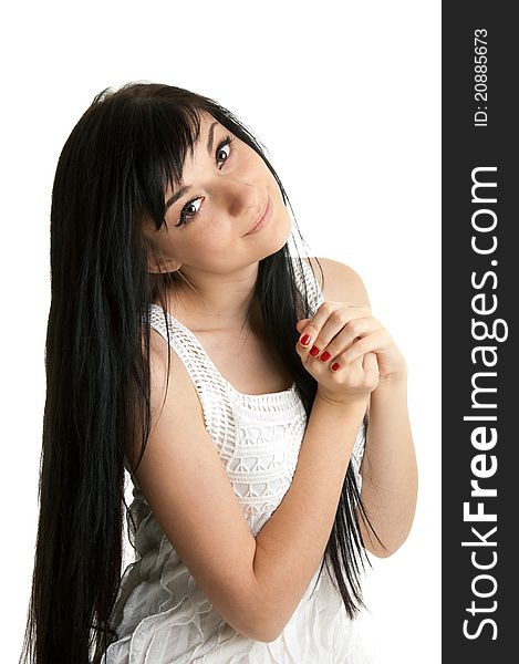 Beautiful brunette girl wearing a white dress putting her hands and standing on white background