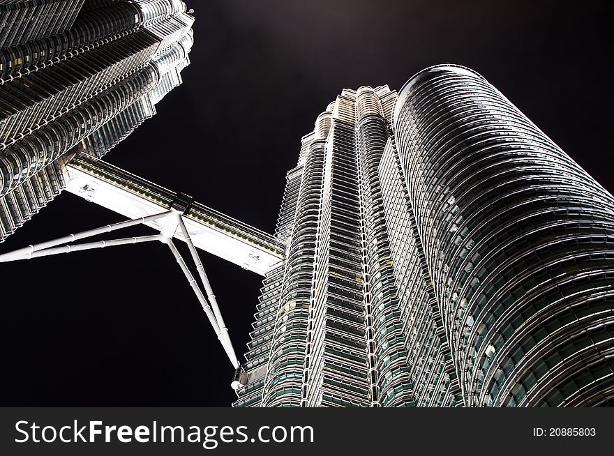 A night view of the Petronas Twin Towers in Kuala Lumpur, Malaysia, Asia. The towers feature a skybridge between the two towers on 41st and 42nd floors, which is the highest 2-story bridge in the world. It is not attached to the main structure, but is instead designed to slide in and out of the towers to prevent it from breaking, as the towers sway several feet in towards and away from each other during high winds. A night view of the Petronas Twin Towers in Kuala Lumpur, Malaysia, Asia. The towers feature a skybridge between the two towers on 41st and 42nd floors, which is the highest 2-story bridge in the world. It is not attached to the main structure, but is instead designed to slide in and out of the towers to prevent it from breaking, as the towers sway several feet in towards and away from each other during high winds.