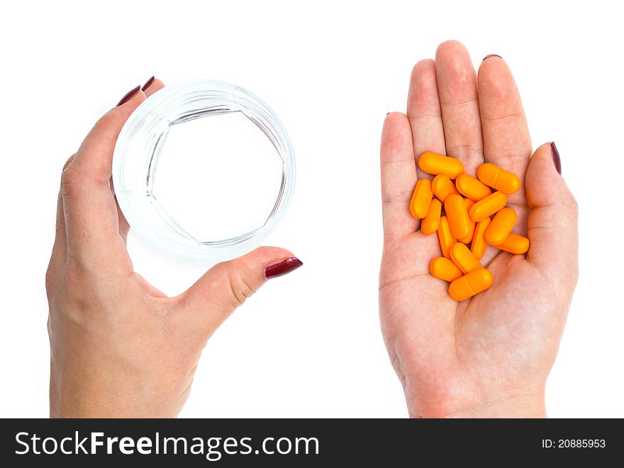 Close-up woman's hands with pills and glass of water. Close-up woman's hands with pills and glass of water
