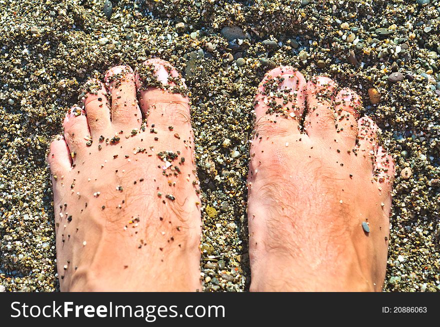 Feet on the wet shingle beach