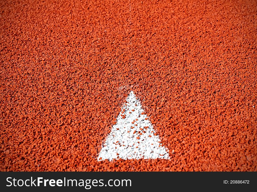 A arrow sign on running track