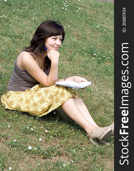 Girl sitting on grass in park