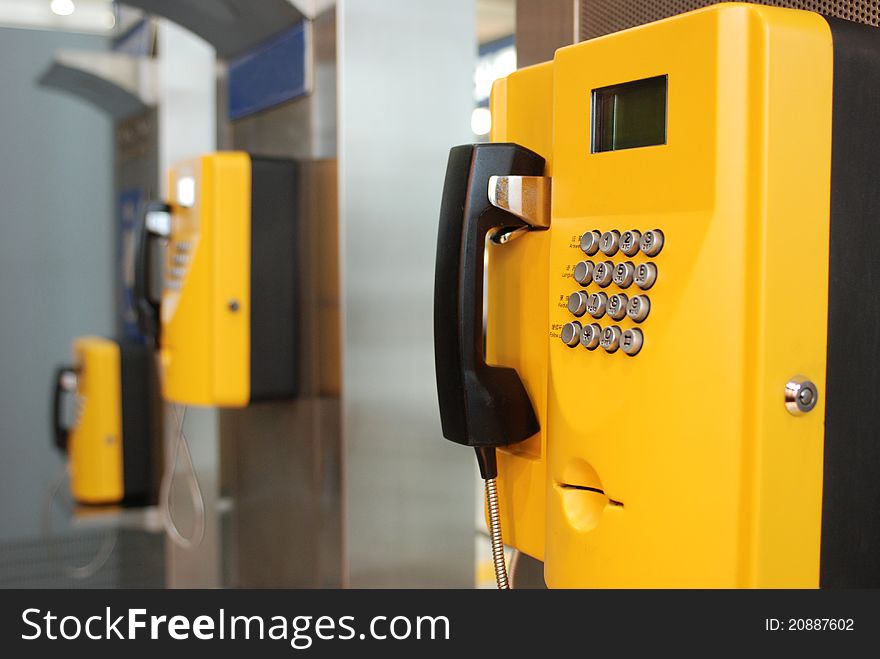 Yellow public telephones with emergency icons