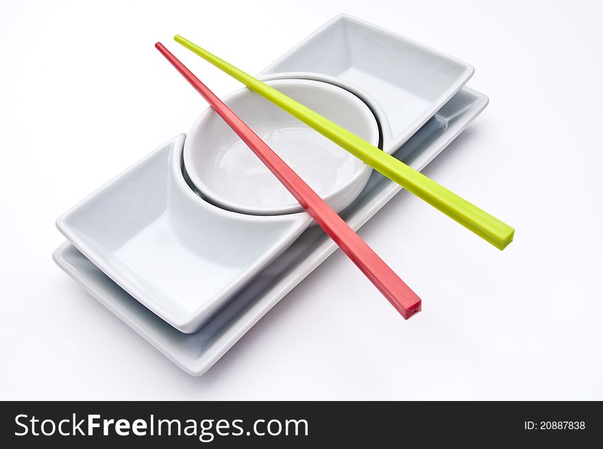 Plain white empty salad dishes with coloured chopsticks. Plain white empty salad dishes with coloured chopsticks
