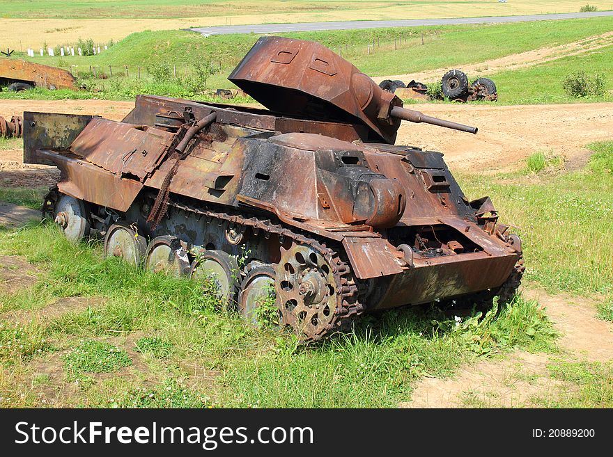 Strongly becoming rusty from time, the damaged tank of period of the second world war stands on a small hillock.