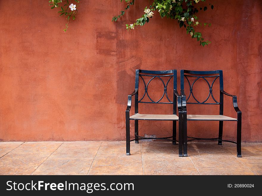 Brown background with a climber and chair