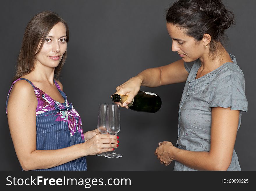 Two attractive women drinking champagne. Two attractive women drinking champagne