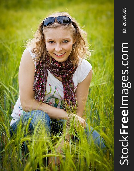 Young girl in wheat field in summer