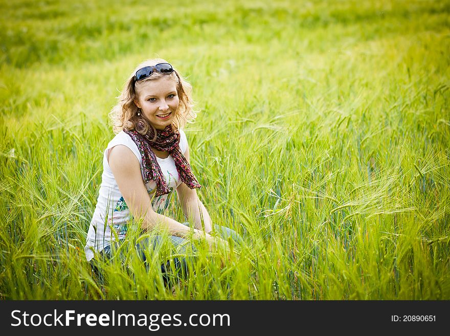 Young girl in wheat field in summer