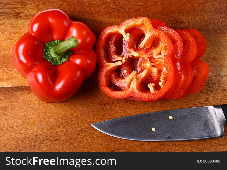 Image of sweet red pepper sliced on hardboard