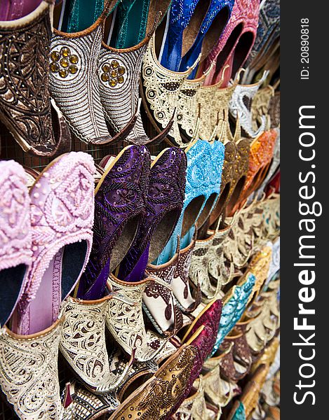 Rows of colorful shoes at the market in Dubai.