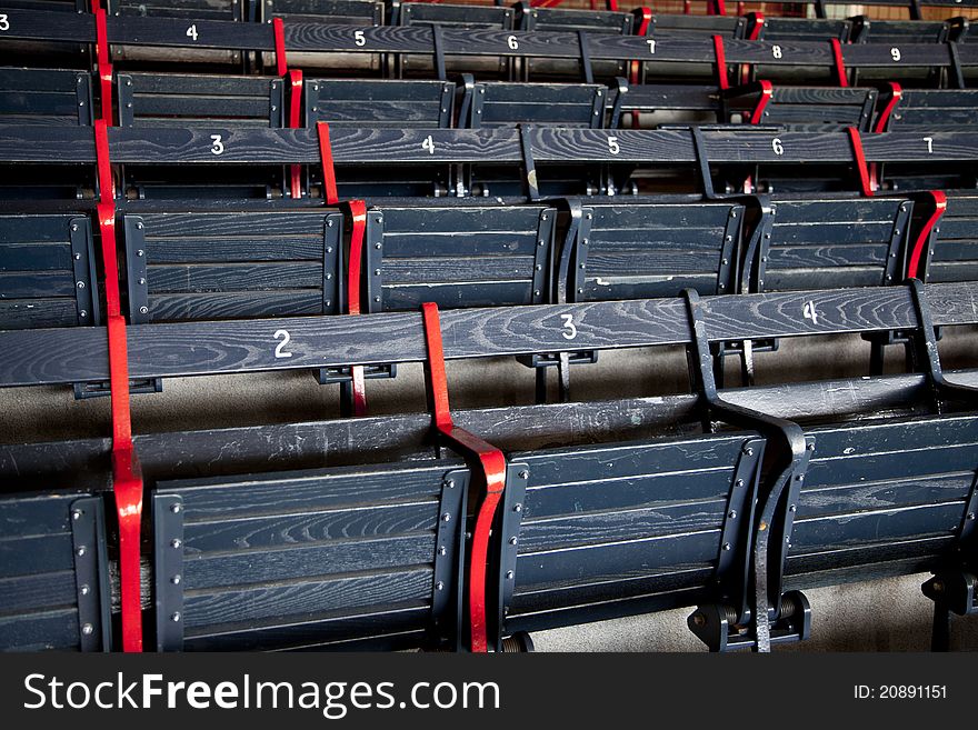 Rows of blue numbered wooden seats. Rows of blue numbered wooden seats