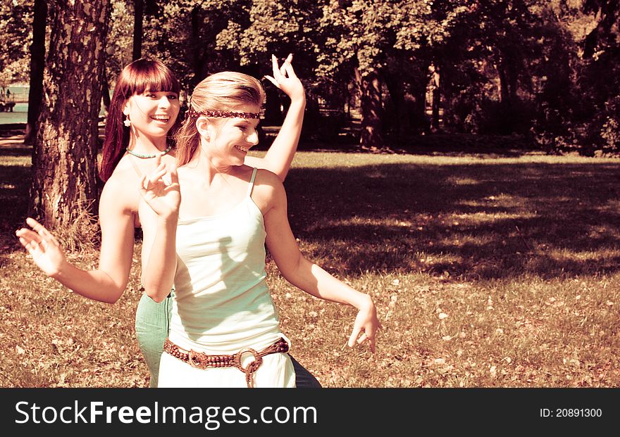 Two beautiful happy sisters outdoors. Two beautiful happy sisters outdoors